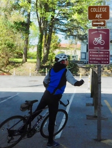 photo of bicyclist reading wayfinding signage on Hall Trail