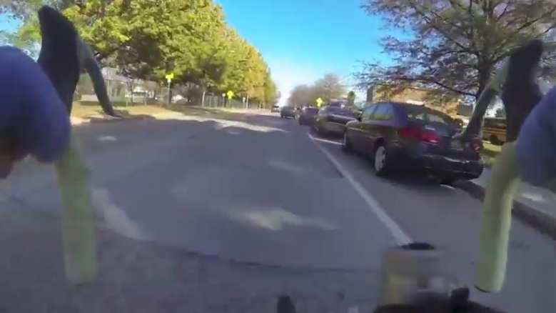photo of cars parked in bike lanes in front of Newark High School
