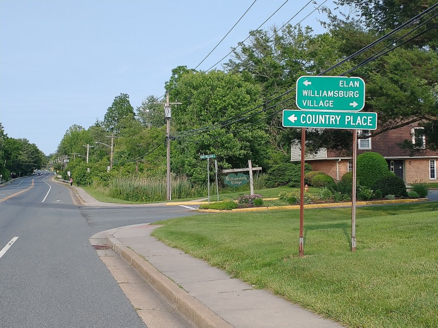 Two road signs off Barksdale Road, pointing out three neighborhoods: Elan and Country Place to the left, and Williamsburg Village to the right.