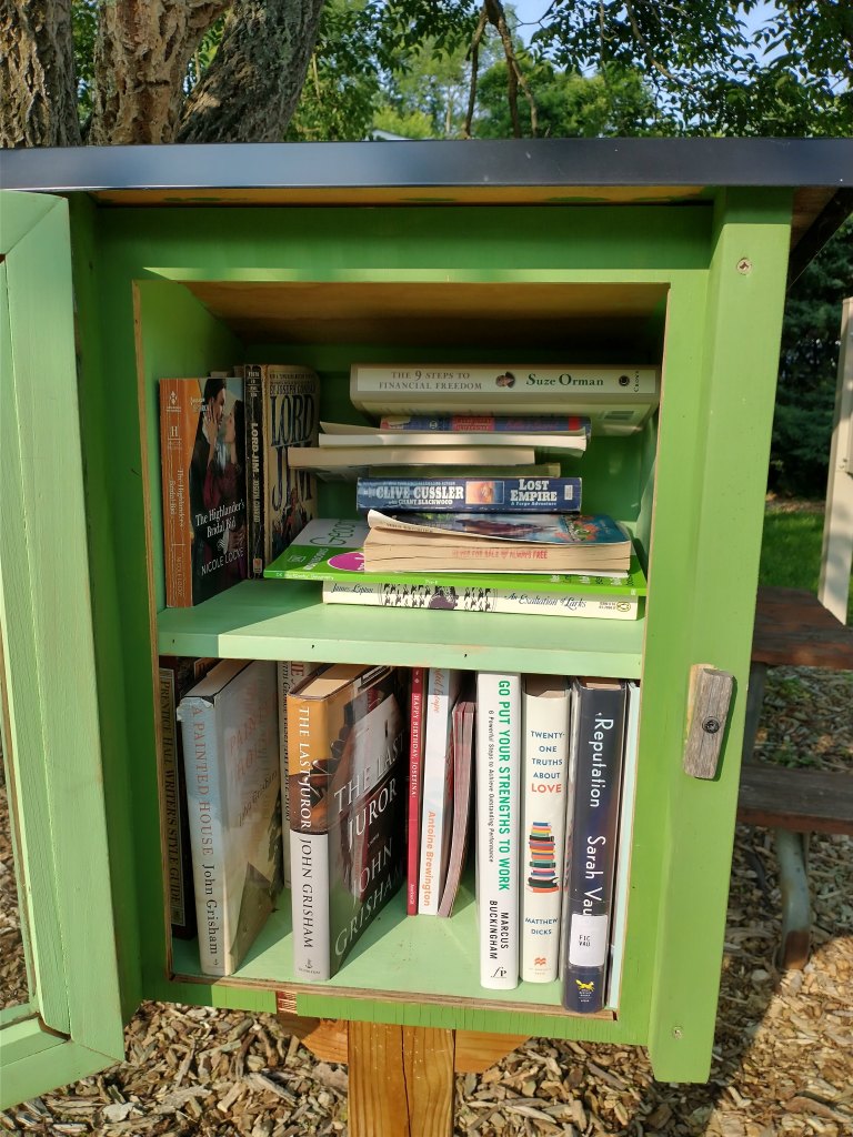 The Little Free Library at Rahway Park. There are multiple John Grisham books on the bottom shelf.