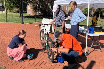 photo of Chip Kneavel inflating a student's tire