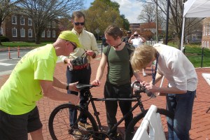 photo of BikeNewark volunteers helping a student with her bicycle and helmet